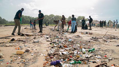 Volunteers removing trash from a beach